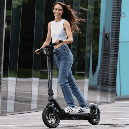 Woman riding an electric scooter in an urban setting