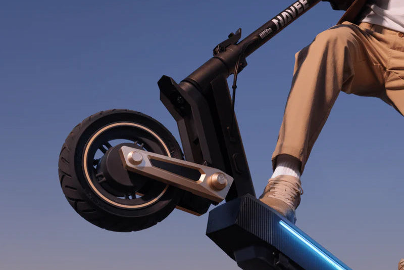 Person riding a scooter with a cityscape in the background