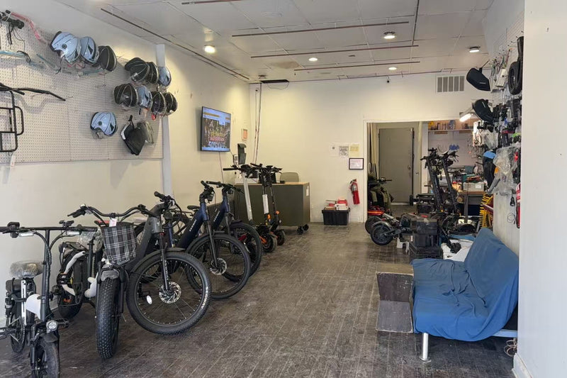 Room with electric bikes and accessories on display