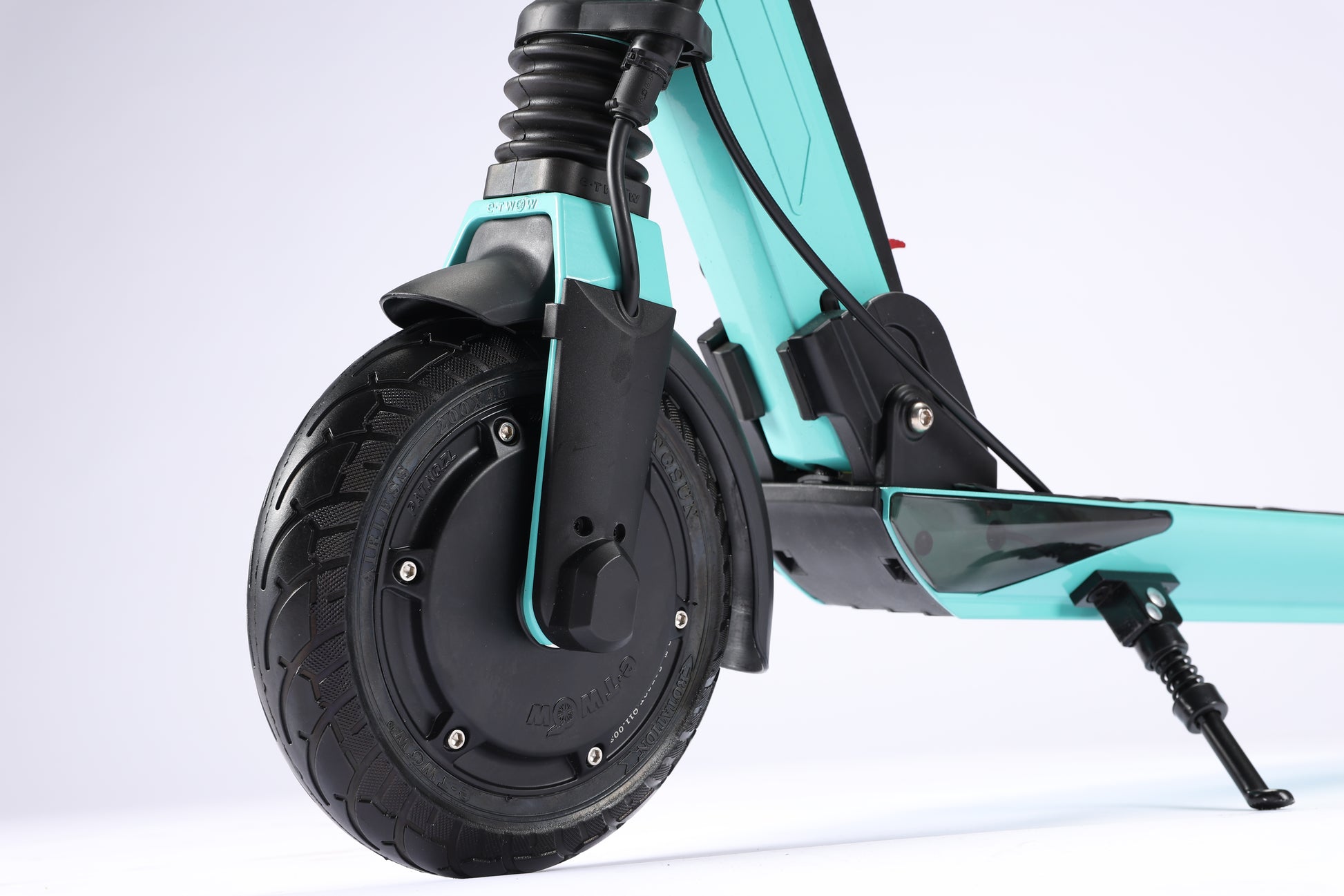 Close-up of a turquoise electric scooter with a black wheel on a white background